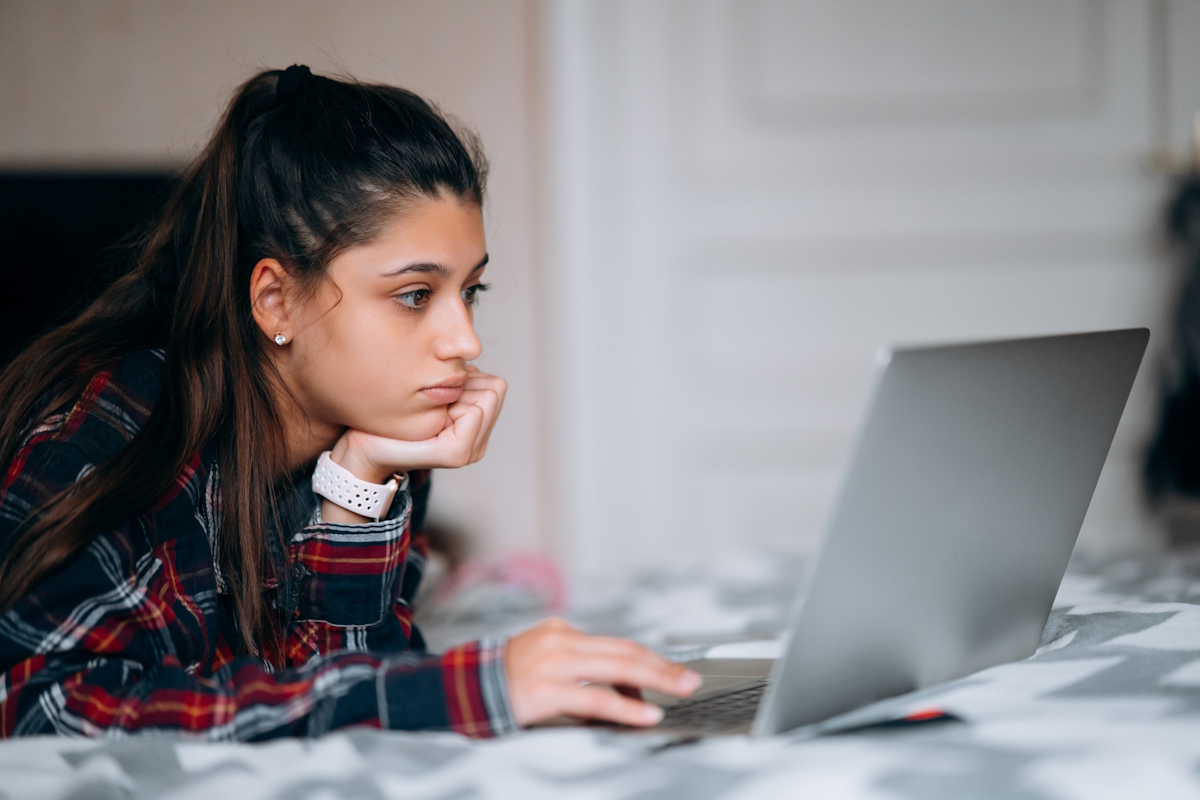 woman using a cheap laptop